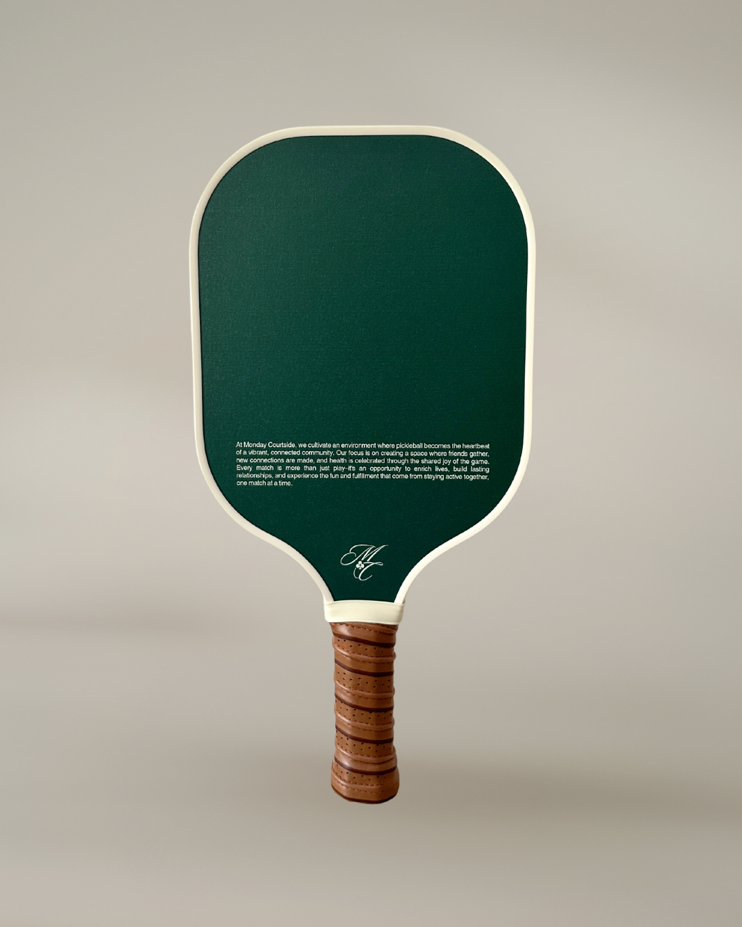 Pickleball paddle with green face and wooden handle on a light gray background