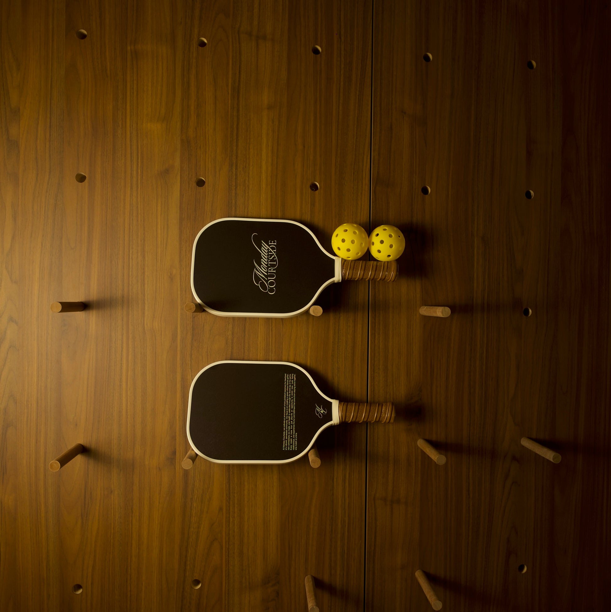 2 brown pickleball paddles lying horizontally on a clean surface, designed for comfort, control, and timeless style