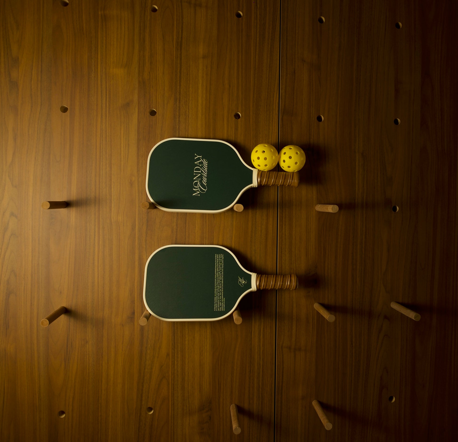 2 green pickleball paddles lying horizontally on a clean surface, designed for comfort, control, and timeless style